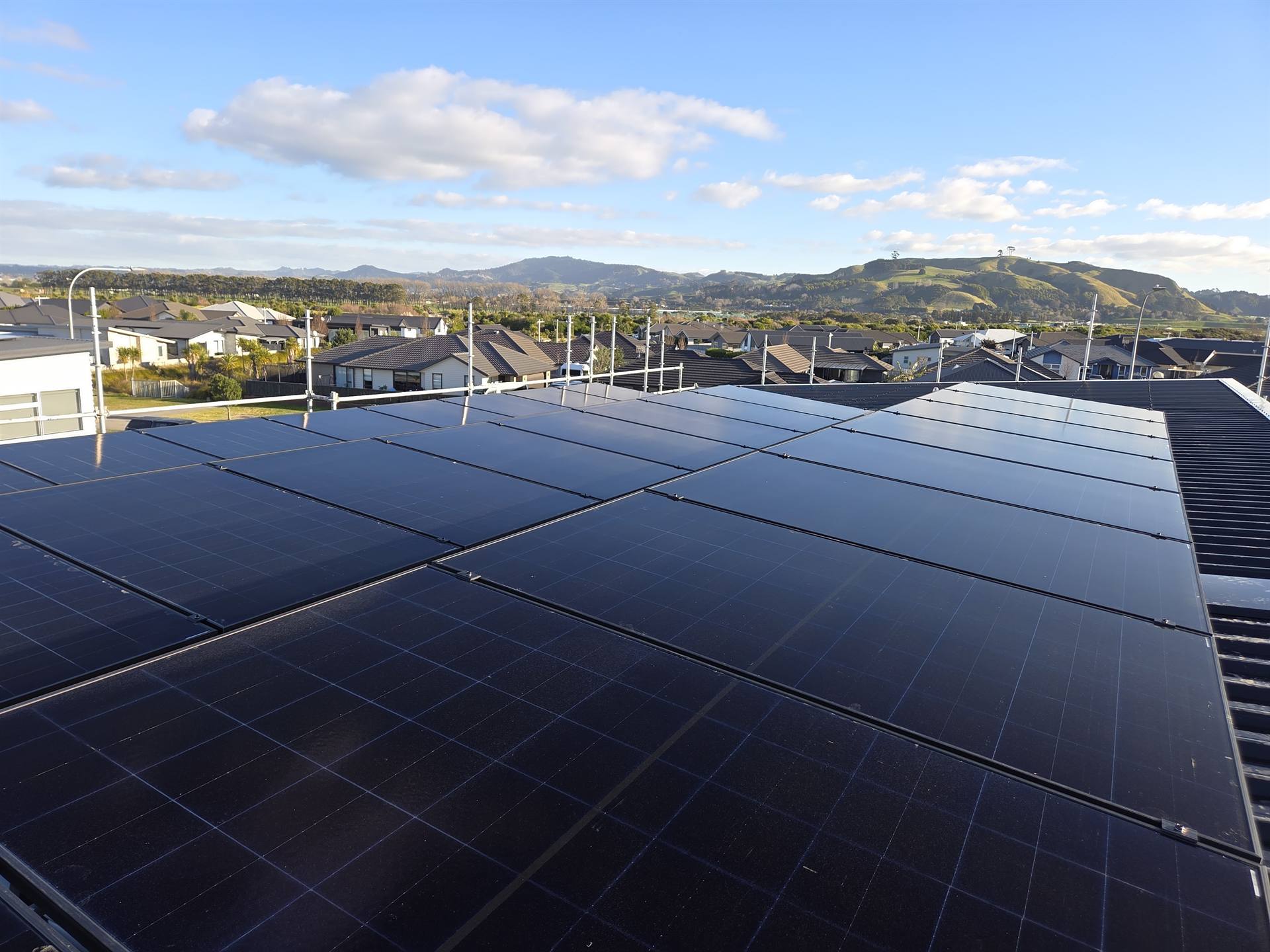 Rooftop solar panel installation overlooking Tauranga, New Zealand - Watt Works